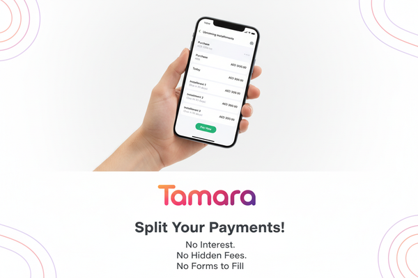 Create a clean, modern portrait-mode promotional banner for Tamara (Buy Now Pay Later). The image should be vertical (aspect ratio 4:5 or 9:16). On the upper half, show a close-up of a hand holding a smartphone displaying a Tamara payment summary screen with upcoming installments. On the lower half or right side, place the official Tamara gradient logo (pink–orange–purple). Add bold headline text: ‘Split Your Payments!’ and smaller text below: ‘No Interest. No Hidden Fees. No Forms to Fill.’ Use a bright wh